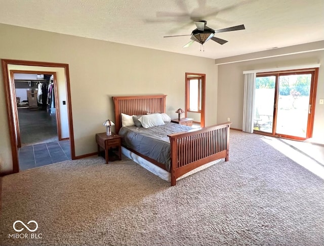 carpeted bedroom with access to outside, a textured ceiling, and ceiling fan