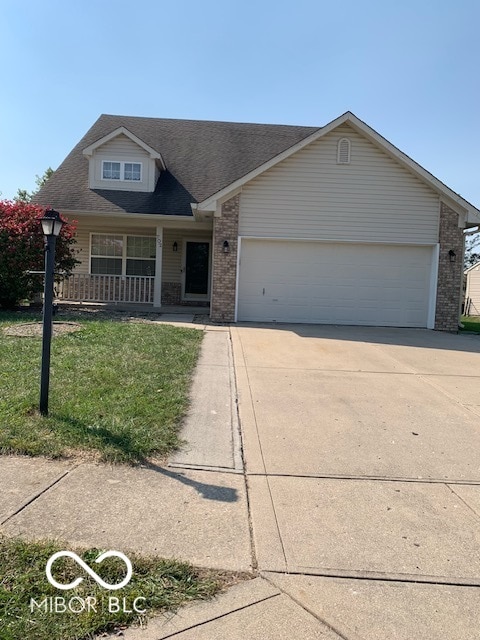 view of front facade with a garage and a front lawn