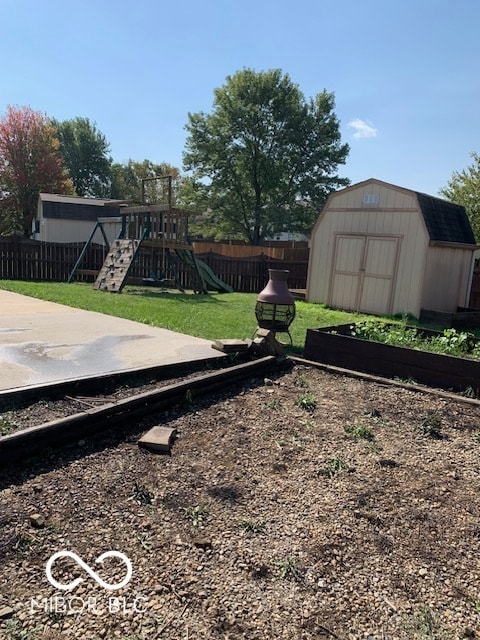 view of yard featuring a playground and a storage unit