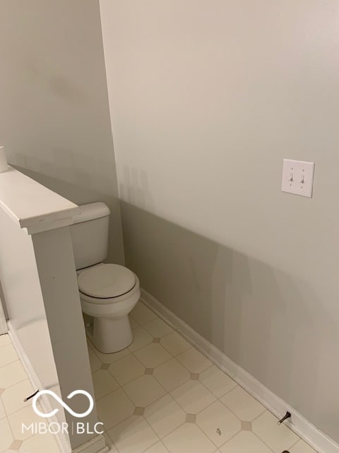 bathroom with toilet and tile patterned floors