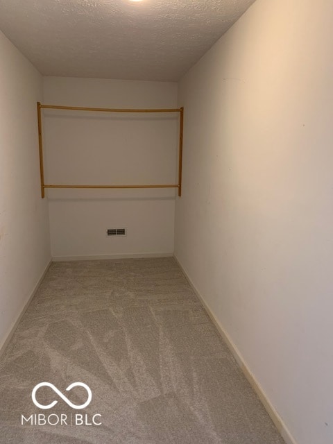 carpeted spare room featuring a textured ceiling