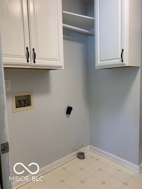 laundry room featuring hookup for a washing machine and cabinets