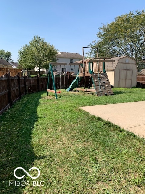 view of play area with a yard and a storage unit