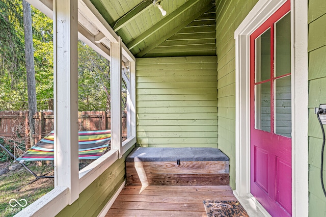 unfurnished sunroom featuring wood ceiling and plenty of natural light