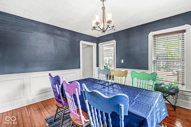 dining space with an inviting chandelier and dark wood-type flooring