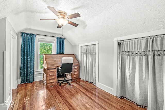 office with ceiling fan, hardwood / wood-style flooring, vaulted ceiling, and a textured ceiling