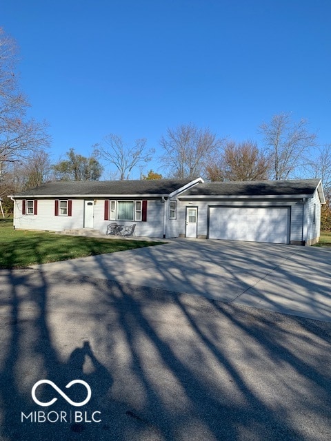 ranch-style house with a garage and a front yard