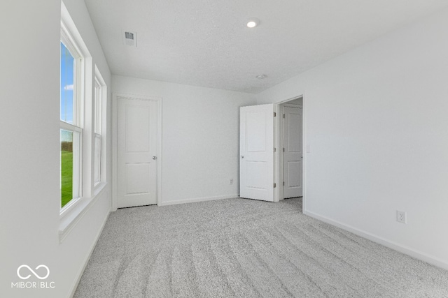 unfurnished room featuring light colored carpet