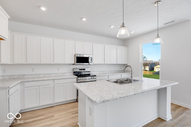 kitchen with sink, stainless steel appliances, and white cabinets