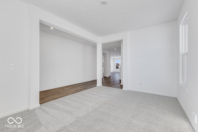 unfurnished room featuring dark carpet