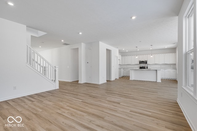 unfurnished living room with light hardwood / wood-style floors