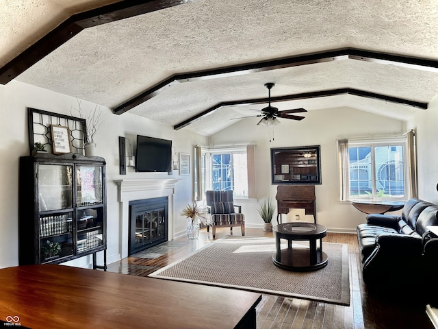 610 E Morgan St, Martinsville, IN 46151 - living room with wood finished floors, ceiling fan, a textured ceiling, a glass covered fireplace, and baseboards