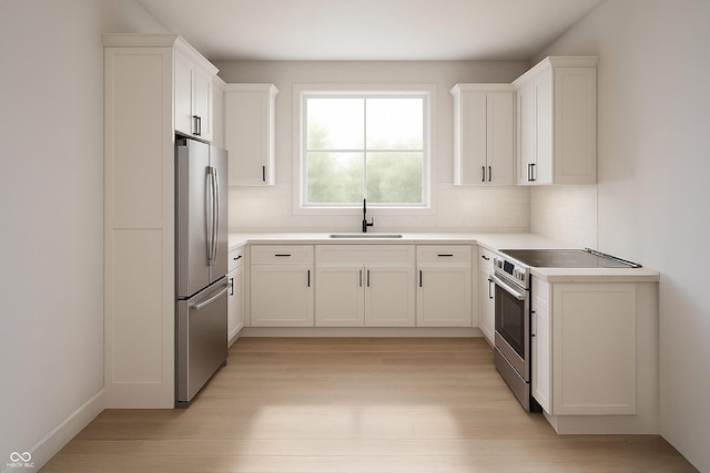 610 E Morgan St, Martinsville, IN 46151 - kitchen featuring stainless steel appliances, a sink, light wood-style floors, backsplash, and white cabinetry