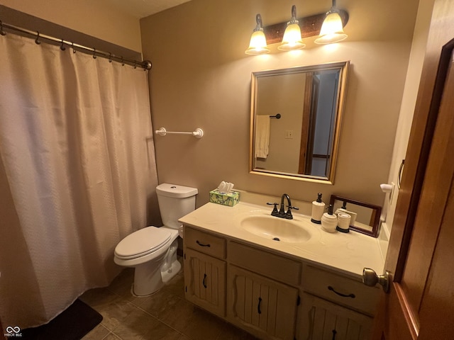 bathroom with vanity, tile patterned flooring, and toilet