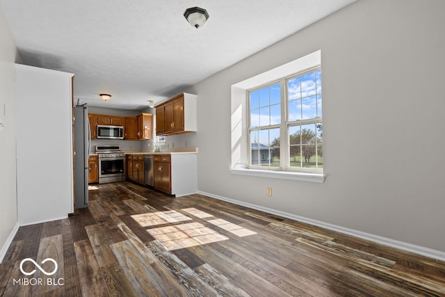 kitchen featuring appliances with stainless steel finishes, dark hardwood / wood-style floors, and sink