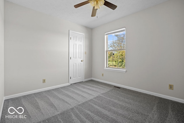 unfurnished room featuring a textured ceiling, carpet, and ceiling fan