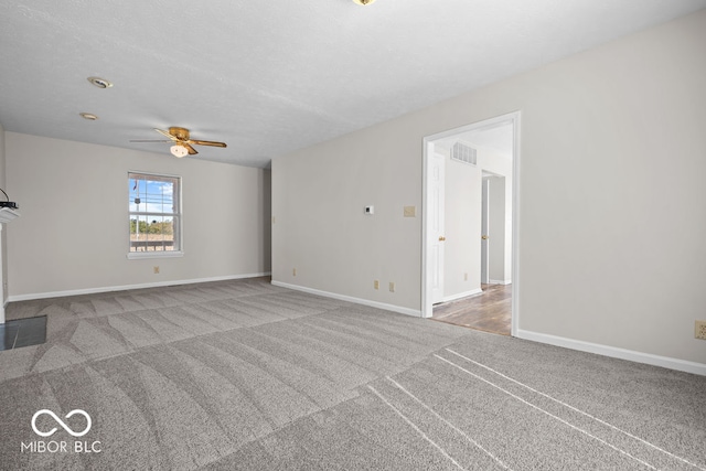 unfurnished living room featuring ceiling fan and carpet