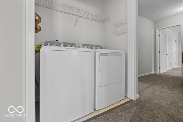 washroom featuring washing machine and clothes dryer and carpet flooring