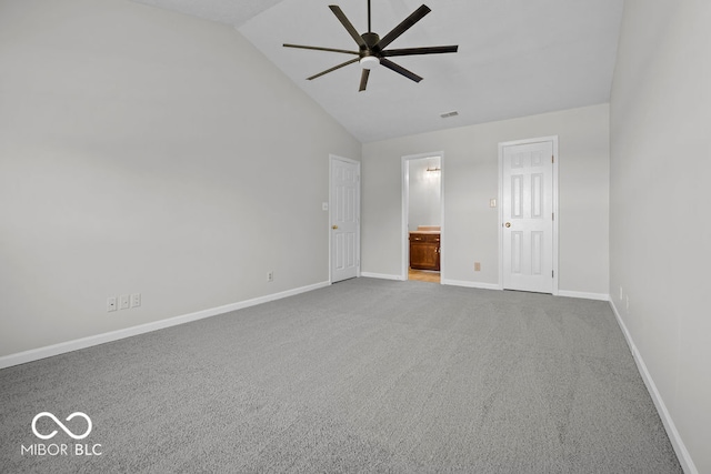 carpeted spare room with ceiling fan and vaulted ceiling