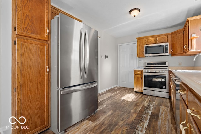 kitchen featuring sink, appliances with stainless steel finishes, and dark hardwood / wood-style flooring