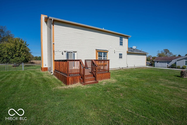 back of property with a lawn and a deck