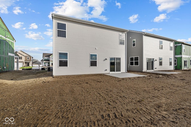 back of property featuring cooling unit and a patio