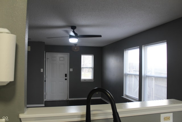 kitchen with ceiling fan and a textured ceiling