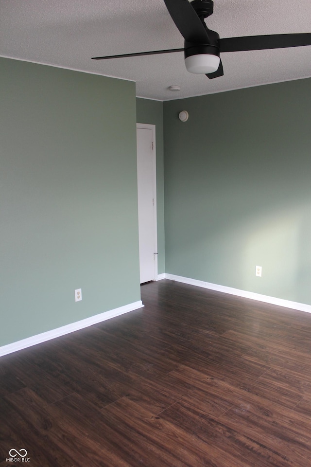 spare room featuring ceiling fan, a textured ceiling, and dark hardwood / wood-style floors