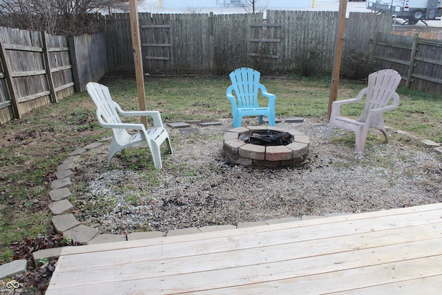 view of yard featuring a deck and an outdoor fire pit