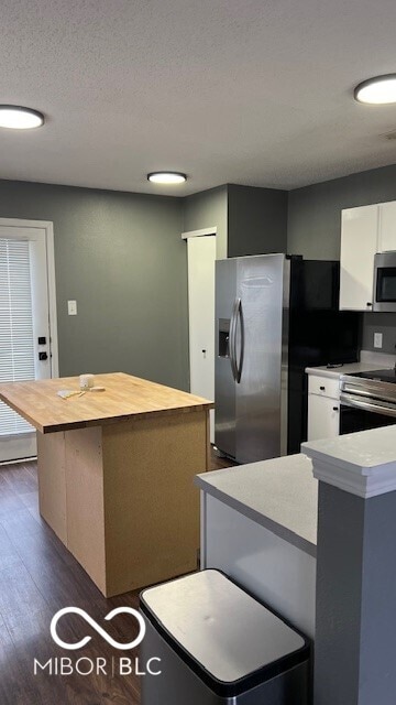 kitchen with white cabinets, appliances with stainless steel finishes, and a kitchen island