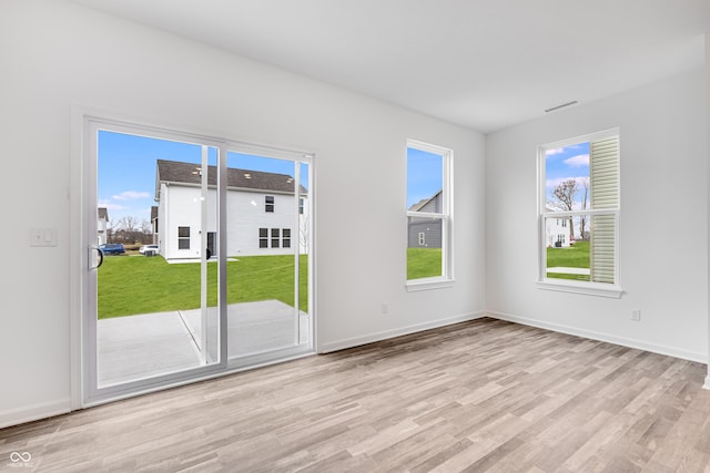 spare room with light hardwood / wood-style floors