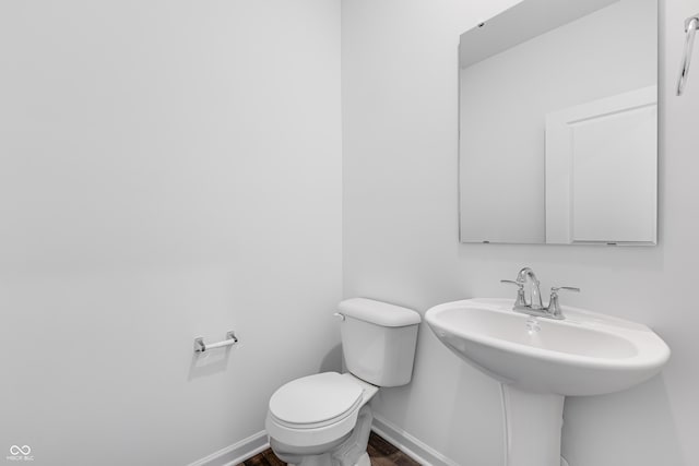 bathroom featuring toilet and sink