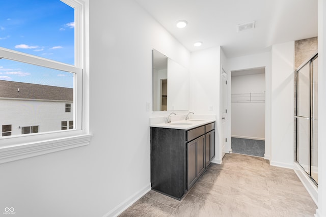 bathroom with vanity and an enclosed shower