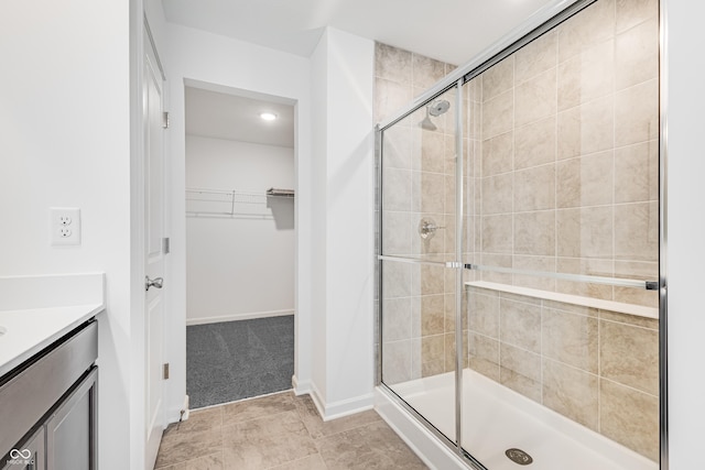 bathroom featuring vanity and an enclosed shower