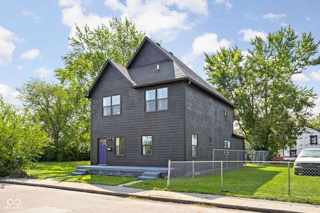 view of side of home with a yard