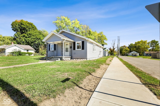 bungalow-style house with a front lawn and a porch