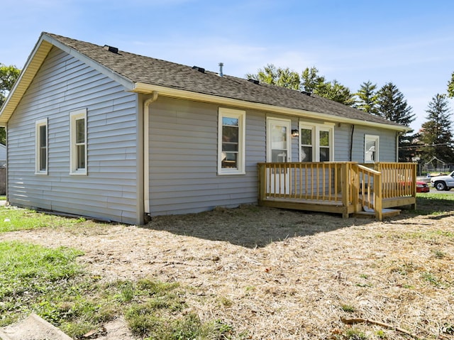 rear view of house featuring a wooden deck