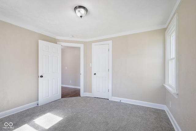 unfurnished bedroom featuring carpet floors, a closet, and multiple windows