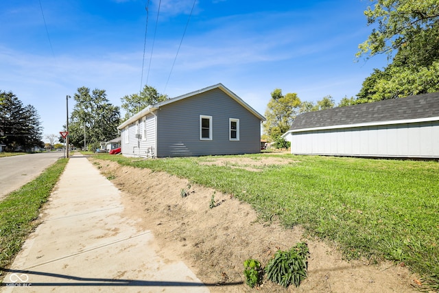 view of side of home with a lawn