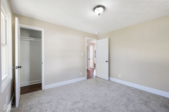 unfurnished bedroom featuring a closet and carpet