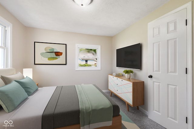 bedroom with carpet floors and a textured ceiling