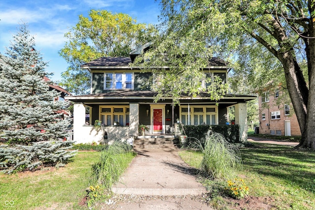 view of front of house with a porch and a front lawn