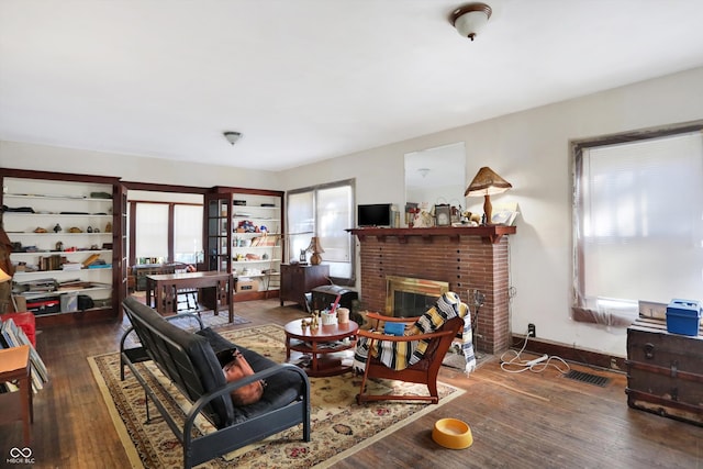 living room featuring a fireplace and dark hardwood / wood-style floors