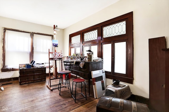 miscellaneous room featuring dark hardwood / wood-style floors and bar area