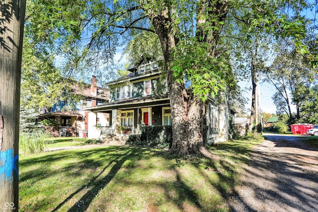 view of front of home with a porch and a front lawn