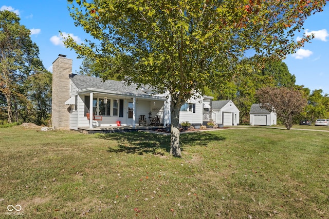 view of front of home featuring a storage shed and a front lawn