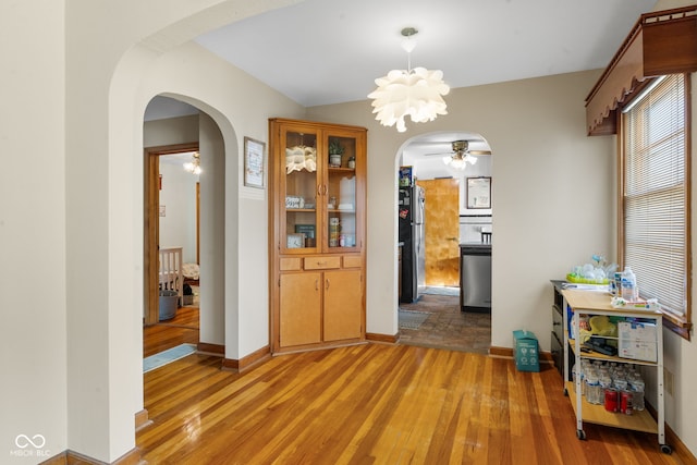 dining room featuring ceiling fan with notable chandelier and light wood-type flooring