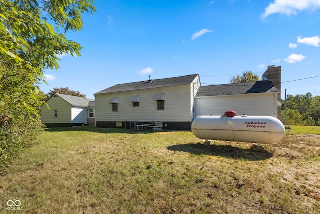 rear view of house featuring a yard