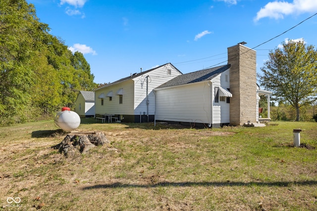 view of property exterior with a yard