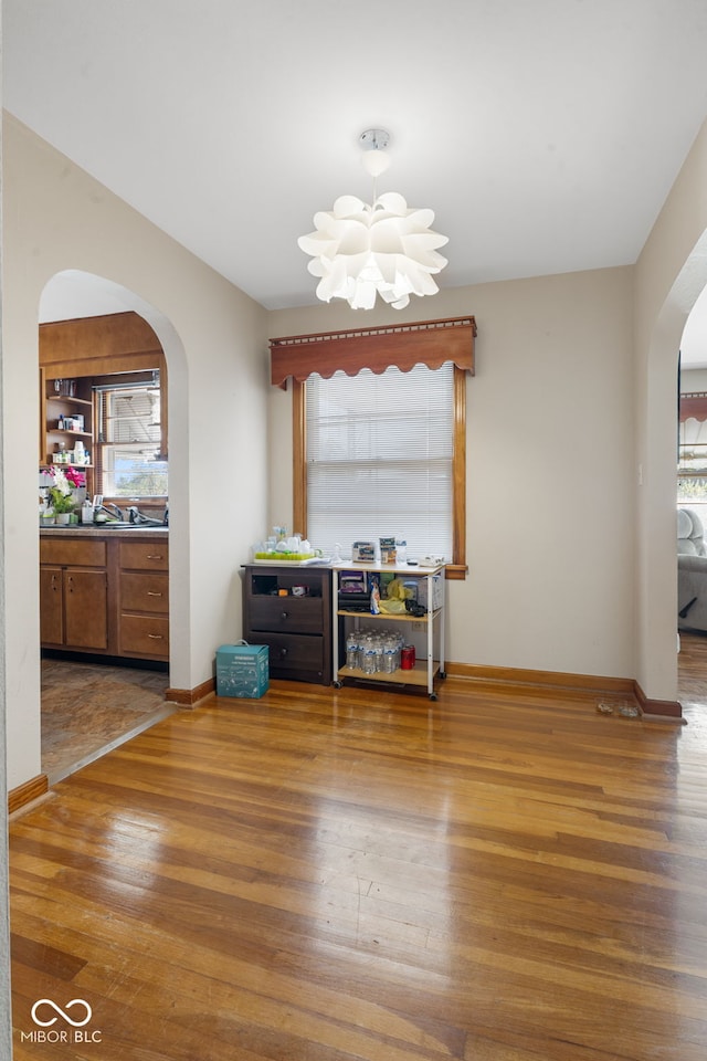 dining space featuring plenty of natural light, a chandelier, and wood-type flooring